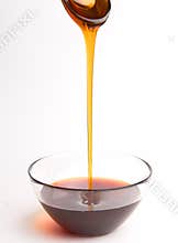 Honey pouring from the spoon