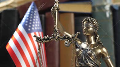 Statue of Lady Justice with Books and USA Flag