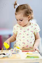 Adorable little girl playing educational toy