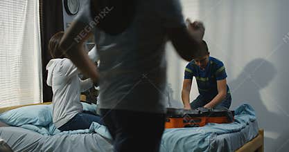 Family packing in bedroom