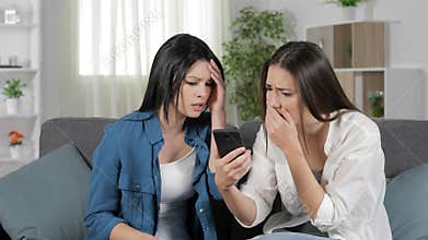 Sad women reading bad news on smart phone