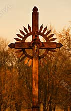 Wooden cross at sunset, sacred place in Lithuania, nature background, warm tint