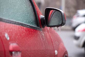 Red car covered with ice