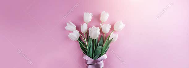 Bouquet of white tulips flowers on pink background. Card for Mothers day, 8 March, Happy Easter. Waiting for spring