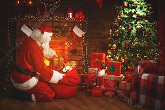 Merry Christmas! santa claus near the fireplace and tree with gi