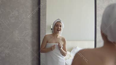 Young woman sings in the bathroom