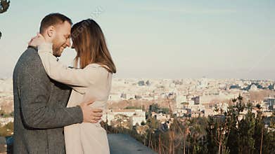 Young beautiful couple hug and kiss against the panorama of Rome, Italy. Romantic date of happy man and woman.