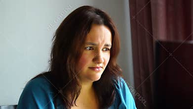 Beautiful young emotional woman in front of computer watching awful thing with horrible scared face bad news information