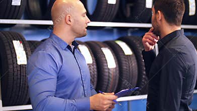 Customer and salesman at car service or auto store