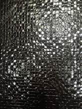 Black shiny textured tile wall background
