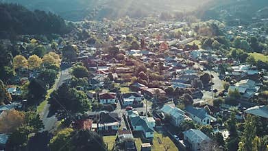 Aerial view houses in residential suburban neighborhood landscapes at sunset lens flare