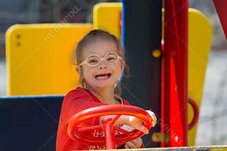 Girl with Down syndrome having fun on the playground