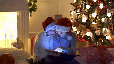 Excited children near Christmas tree