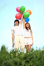 Girl and guy stand with multicoloured balloons