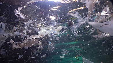 Plastic garbage and other debris floating underwater. Marine pollution. Plastic debris in the water, killing wildlife.