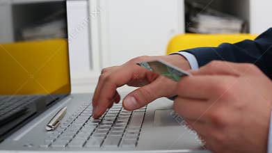 Male hands hold credit card pressing buttons