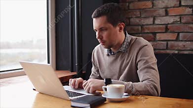 Man working with laptop in cafe
