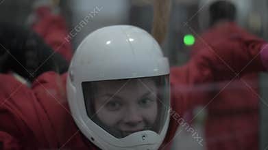 Portrait young woman skydiver flying in wind tunnel. Parachuting and skydiving