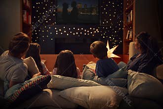 Family Enjoying Movie Night At Home Together