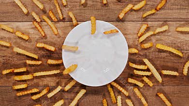 French fries escape from a central plate