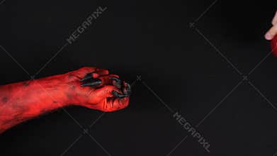 Devil gives a paradise apple to a man.