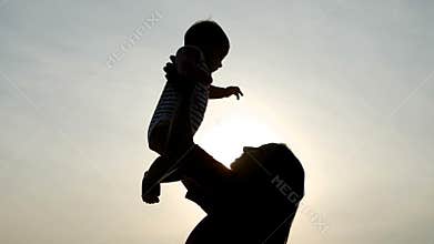 Mom with a young son raises hands up