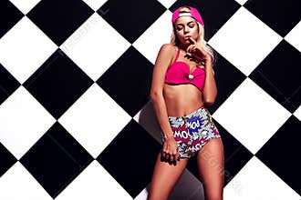 Blond model in rnb style clothes with pink colorful baseball cap