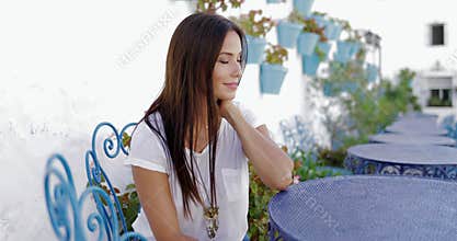 Pensive beautiful model at table