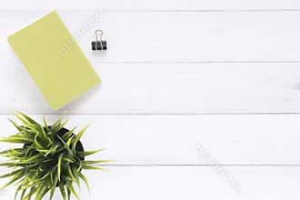 Creative flat lay photo of workspace desk. White office desk wooden table background with mock up notebooks and plant.