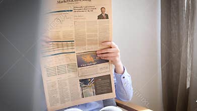 Elegant young woman reading Financial Times uk press