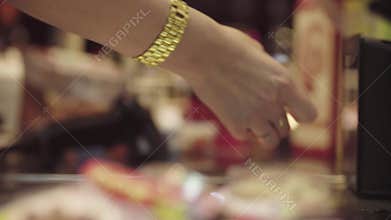 Hands of woman scanning products on cash register