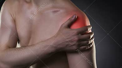 Man with pain in shoulder on black background
