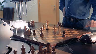 Artificial intelligence, robot chessplayer playing chess with a man. 4K.
