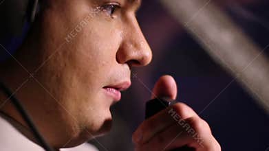 Pilot's face close up, plane crewmember reporting flight details to controller