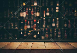 Empty the top of wooden table with blurred counter bar and bottles