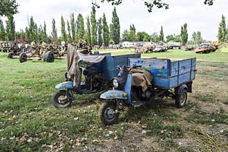 Scooter ant. Old Soviet motor scooter on three wheels with a cart