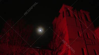 Red haunted house and a full moon