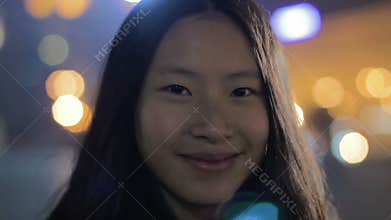 Happy Asian girl pulling faces for camera, smiling and having fun, good actress