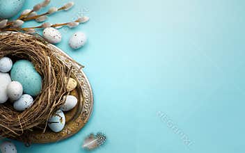Easter background with Easter eggs and spring flowers on blue t