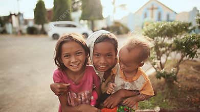 MANILA, PHILIPPINES - JANUARY 5, 2018: Poor Filipino family in Manila Street. Mother and her two children.