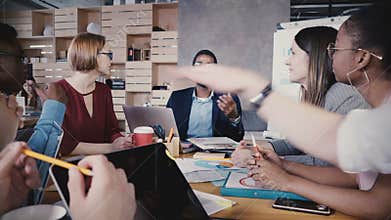 Happy multiethnic people collaborating in office. Young smiling business partners brainstorming, creating new ideas. 4K.