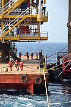 Marine crews work on mooring ropes