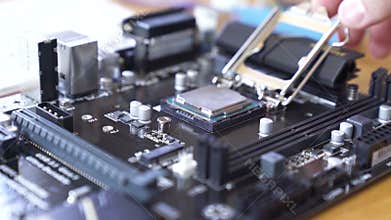 Engineer sets the CPU into the motherboard