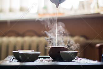 Pouring of Puer Tea from Teapot at Traditional Chinese Tea Ceremony. Set of Equipment for Drinking Tea