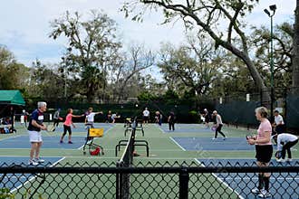 Active Adults Playing Pickleball Outdoors