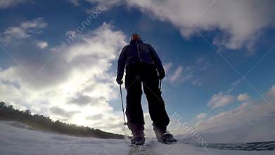Cross country skiing on sunny winter day
