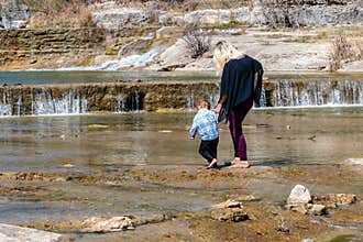 Mother and Daughter Walking in the River
