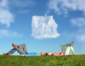 Lying couple on grass and dream house collage