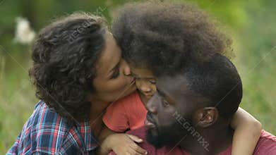 Parents taking care of adopted child, picnic in park, support and understanding