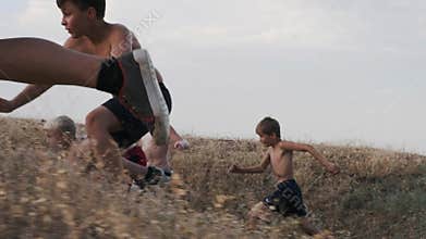A view of running children, competing on a training in a field